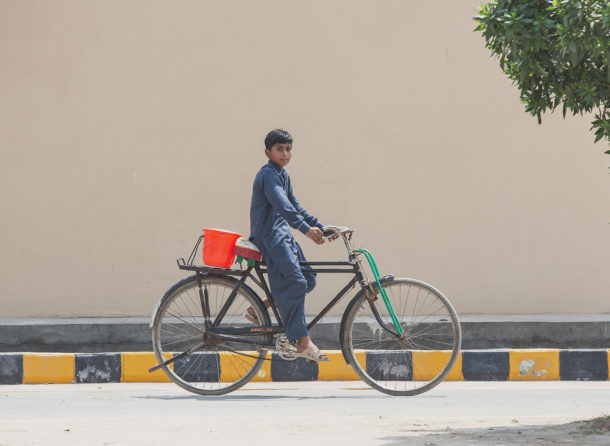Boy cycling on road